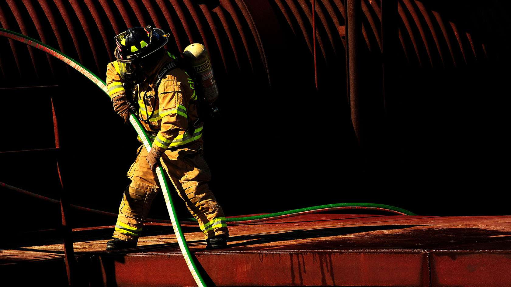 fireman steadying firehose